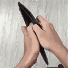 Two hands prising open an empty wallet, finding nothing inside.